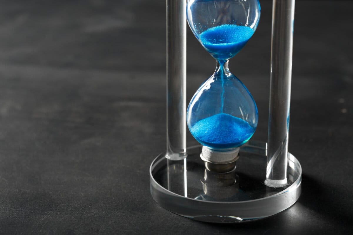 Time is passing Blue hourglass close up