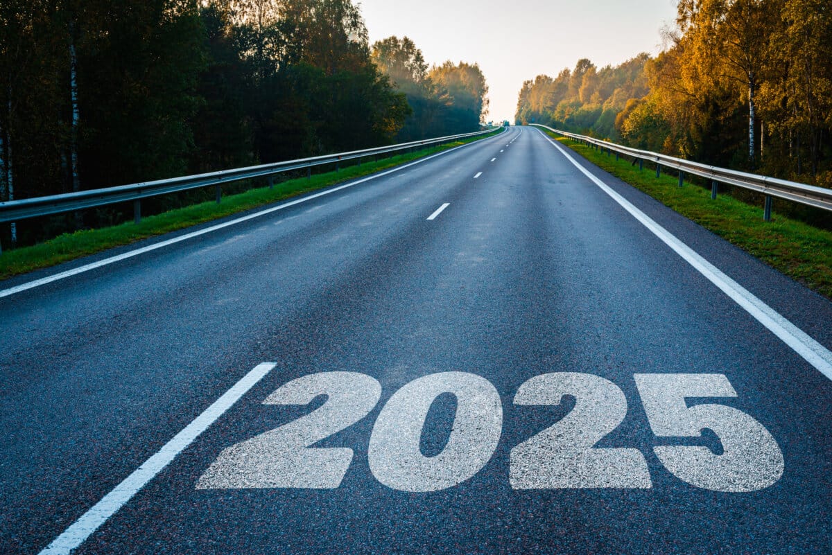 The goal word calendar written on highway road in the middle of empty asphalt road at golden sunset and beautiful blue sky Concept for year